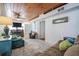 Living room with wood ceilings, brick wall, fireplace, seating and soft rug at 405 Palmetto Blvd, Edisto Island, SC 29438