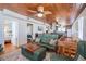 Open-concept living area with kitchen view, cozy sofa, and access to a bedroom at 405 Palmetto Blvd, Edisto Island, SC 29438
