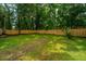 Lush backyard with a well-maintained lawn, mature trees, and a newly installed wooden fence at 4233 Oakridge Dr, North Charleston, SC 29418