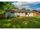 Backyard view of a freshly painted home featuring a grassy lawn and sliding glass doors at 4233 Oakridge Dr, North Charleston, SC 29418