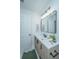 Modern bathroom with decorative light fixture, wooden vanity and sink with black hardware at 4233 Oakridge Dr, North Charleston, SC 29418