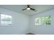 This bright bedroom has two windows and a ceiling fan with hardwood floors at 4233 Oakridge Dr, North Charleston, SC 29418