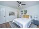 Bright bedroom features a ceiling fan, gray rug, and a comfortable bed with yellow pillows at 4233 Oakridge Dr, North Charleston, SC 29418