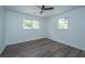 Bright, airy bedroom with neutral paint and wood-look flooring. Two windows offer natural light at 4233 Oakridge Dr, North Charleston, SC 29418