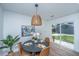 Cozy dining area with modern light fixture, hardwood floors, and backyard view at 4233 Oakridge Dr, North Charleston, SC 29418