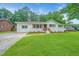 Charming one-story home with brick facade, a well-maintained lawn, and inviting curb appeal at 4233 Oakridge Dr, North Charleston, SC 29418