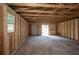 Unfinished garage with exposed beams and a view to the exterior at 4233 Oakridge Dr, North Charleston, SC 29418