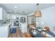 Bright eat-in kitchen features white cabinets, stainless steel appliances, and a dining table at 4233 Oakridge Dr, North Charleston, SC 29418
