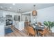 Open kitchen and dining area with stainless appliances, white cabinets, and pendant lighting at 4233 Oakridge Dr, North Charleston, SC 29418