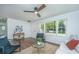 Bright living room featuring hardwood floors, ceiling fan, and neutral decor with large windows at 4233 Oakridge Dr, North Charleston, SC 29418
