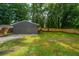 Outbuilding featuring vertical wood planks, a freshly painted exterior, and manicured lawn at 4233 Oakridge Dr, North Charleston, SC 29418