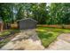 Backyard view of a one-car garage featuring a concrete driveway and fenced perimeter at 4233 Oakridge Dr, North Charleston, SC 29418