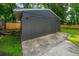 Outbuilding featuring vertical planks, a freshly painted exterior, and concrete slab at 4233 Oakridge Dr, North Charleston, SC 29418