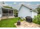 Backyard includes a screened-in porch and a patio with a grill on a grassy lawn at 4953 W Liberty Park Cir, North Charleston, SC 29405