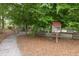 Charming community space featuring benches, mature trees, a gravel path, and a neighborhood library at 4953 W Liberty Park Cir, North Charleston, SC 29405