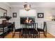 Bright dining room features hardwood floors, white wainscoting, and an elegant light fixture at 4953 W Liberty Park Cir, North Charleston, SC 29405