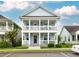 Inviting two-story home features a charming double porch, surrounded by well-maintained landscaping at 4953 W Liberty Park Cir, North Charleston, SC 29405