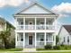 Charming two-story home with a double porch, light blue siding, and white trim at 4953 W Liberty Park Cir, North Charleston, SC 29405