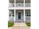 Close-up of the home's entryway, displaying a charming black front door and covered porch at 4953 W Liberty Park Cir, North Charleston, SC 29405