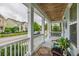 The home's relaxing front porch provides seating and a charming neighborhood view at 4953 W Liberty Park Cir, North Charleston, SC 29405