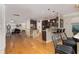 Open-concept kitchen flows into the living area, featuring an island with seating and stainless steel appliances at 4953 W Liberty Park Cir, North Charleston, SC 29405