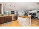 Open-concept kitchen and dining area with stainless steel appliances, granite countertops, and a center island at 4953 W Liberty Park Cir, North Charleston, SC 29405