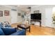 Bright living room featuring wood floors, comfortable blue seating, and stylish decor at 4953 W Liberty Park Cir, North Charleston, SC 29405