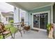 Comfortable outdoor porch with seating, offers a relaxing spot with a pleasant neighborhood view at 4953 W Liberty Park Cir, North Charleston, SC 29405