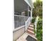 A charming porch entryway with steps bordered by lush greenery welcomes you to the home at 4953 W Liberty Park Cir, North Charleston, SC 29405