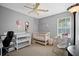 Bedroom with crib, changing table, and accent chair at 503 Amberjack Way, Summerville, SC 29485