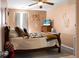 Comfortable bedroom featuring a decorative bed, ceiling fan, window, and warm neutral color scheme at 508 Glady Rd, Moncks Corner, SC 29461