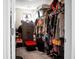 A cluttered walk-in closet filled with clothing, storage bins, and personal belongings at 508 Glady Rd, Moncks Corner, SC 29461