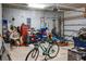 Cluttered garage with a bicycle, lawnmower, storage containers, and garage door opener at 508 Glady Rd, Moncks Corner, SC 29461