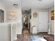 Bright hallway with wood floors, decorative wall art, white trim, and glimpses into adjacent rooms at 508 Glady Rd, Moncks Corner, SC 29461
