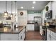 Bright kitchen with stainless steel appliances, white cabinets, stone countertops and modern fixtures at 508 Glady Rd, Moncks Corner, SC 29461