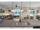 The island features a stainless steel sink and modern faucet with open-concept view of the living area at 508 Glady Rd, Moncks Corner, SC 29461