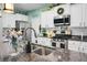 Close-up of stainless steel faucet on granite countertop, white cabinets and stainless appliances in this updated kitchen at 508 Glady Rd, Moncks Corner, SC 29461