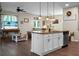 An open-concept kitchen island with pendant lighting overlooking the living area provides an inviting and stylish space at 508 Glady Rd, Moncks Corner, SC 29461