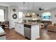 Kitchen island with stainless steel dishwasher and sink overlooking the adjacent living area at 508 Glady Rd, Moncks Corner, SC 29461