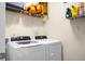 Laundry room with a white front-load washer and dryer, shelf storage, and modern design at 508 Glady Rd, Moncks Corner, SC 29461