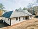 Rear view of the home with white siding, showing the back windows, porch, and yard space at 54 Summer Dr, Walterboro, SC 29488