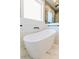 Modern bathroom with freestanding tub, glass shower, and marble tile floors at 54 Summer Dr, Walterboro, SC 29488