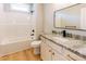 Bright bathroom featuring a shower-tub combo, granite counters, modern fixtures, and light wood floors at 54 Summer Dr, Walterboro, SC 29488