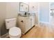 Bathroom with granite counters, modern black fixtures, and light wood floors at 54 Summer Dr, Walterboro, SC 29488