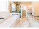 Modern bathroom with freestanding tub, glass shower, and marble tile floors at 54 Summer Dr, Walterboro, SC 29488