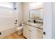 Bright bathroom featuring a shower-tub combo, granite counters, modern fixtures, and light wood floors at 54 Summer Dr, Walterboro, SC 29488