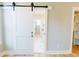 Bedroom with hardwood floors, barn door to bath, walk-in closet, and neutral color paint at 54 Summer Dr, Walterboro, SC 29488