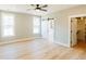Bright bedroom with hardwood floors, barn door to bath, walk-in closet, and natural light at 54 Summer Dr, Walterboro, SC 29488