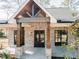 Close up of the front entrance featuring brick accents, sturdy wood pillars, and a welcoming glass door at 54 Summer Dr, Walterboro, SC 29488
