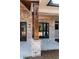 Inviting front porch featuring brick pillars, wood beams and a stylish entry door at 54 Summer Dr, Walterboro, SC 29488